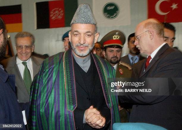 Afghan President Hamid Karzai leaves a ceremony of handing over command of International Security Assistance Force in Kabul, 10 Febraury 2003....