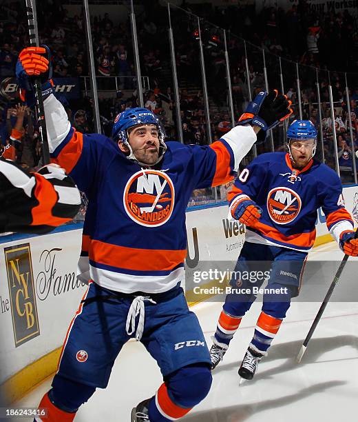 Cal Clutterbuck of the New York Islanders celebrates his goal at 3:40 of the second period against the New York Rangers as he is joined by Michael...