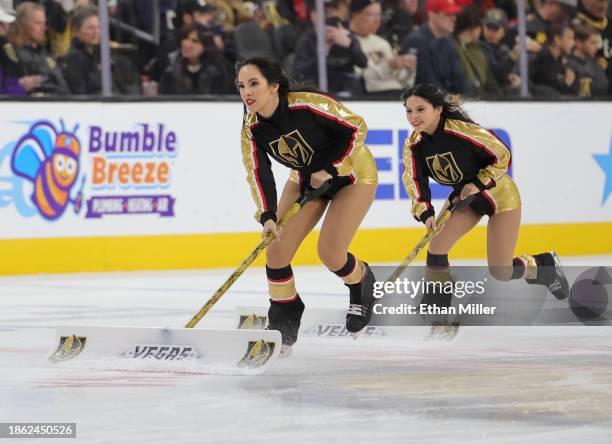 Members of the Knights Guard clean the ice during the Vegas Golden Knights' game against the Calgary Flames at T-Mobile Arena on December 12, 2023 in...