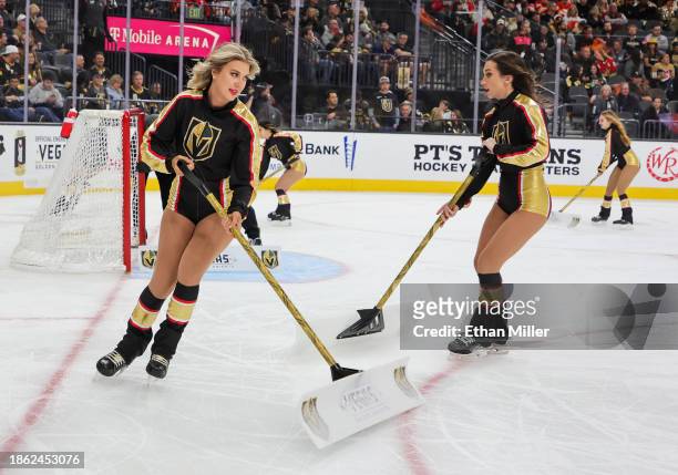Members of the Knights Guard clean the ice during the Vegas Golden Knights' game against the Calgary Flames at T-Mobile Arena on December 12, 2023 in...