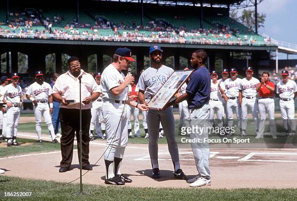 Harold Baines of the Texas Rangers is honored by the Chicago White Sox prior to the start of a Major League Baseball game circa 1989 at Comiskey Park...