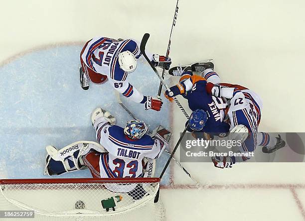 Cam Talbot, Ryan McDonagh and Benoit Pouliot of the New York Rangers defend against Thomas Vanek of the New York Islanders at the Nassau Veterans...