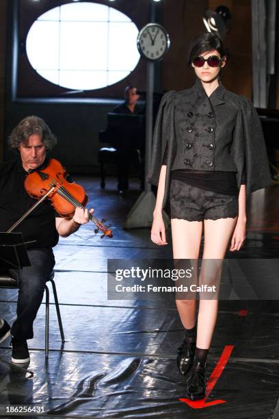 Model walks the runway during Alexandre Herchcovitch show at Sao Paulo Fashion Week Winter 2014 on October 29, 2013 in Sao Paulo, Brazil.