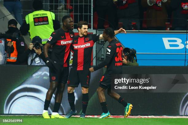 Victor Boniface of Bayer Leverkusen celebrates with Jonas Hofmann and Jeremie Frimpong of Bayer Leverkusen after scoring their team's first goal...