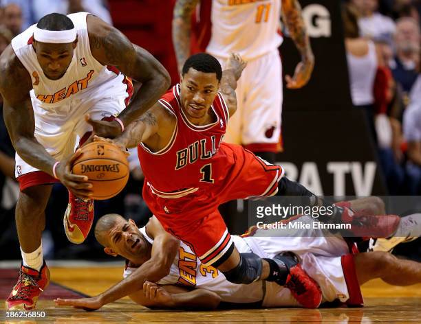 Derrick Rose of the Chicago Bulls, LeBron James and Shane Battier of the Miami Heat fight for a loose ball during a game at American Airlines Arena...