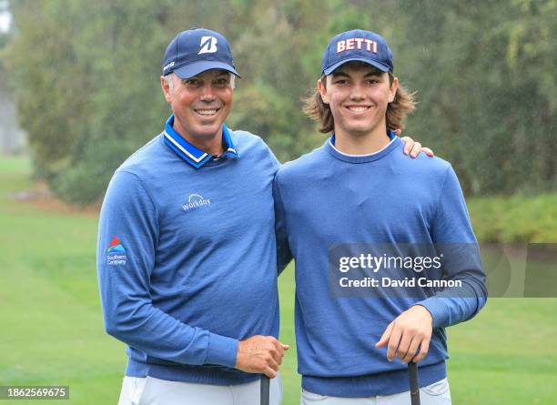 Matt Kuchar of The United States and his son Cameron Kuchar of The United States the first round leaders pose for a picture on the first hole during...