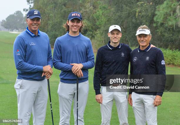 Matt Kuchar of The United States and his son Cameron Kuchar of The United States the first round leaders pose for a picture on the first hole with...