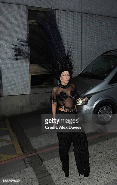 Lady Gaga leaves ITV studios wearing a black peacock feather head piece after filming Graham Norting on October 29, 2013 in London, England.