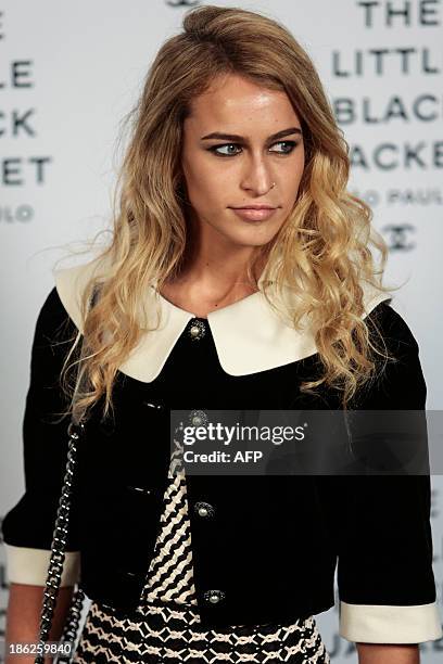 Alice Dellal poses as she arrives for the opening ceremony of the Little Black Jacket exhibition of Chanel in Sao Paulo, Brazil, October 29, 2013....