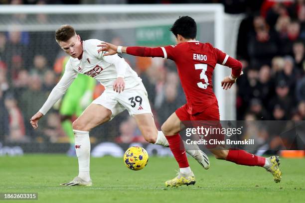 Scott McTominay of Manchester United battles for possession with Wataru Endo of Liverpool during the Premier League match between Liverpool FC and...