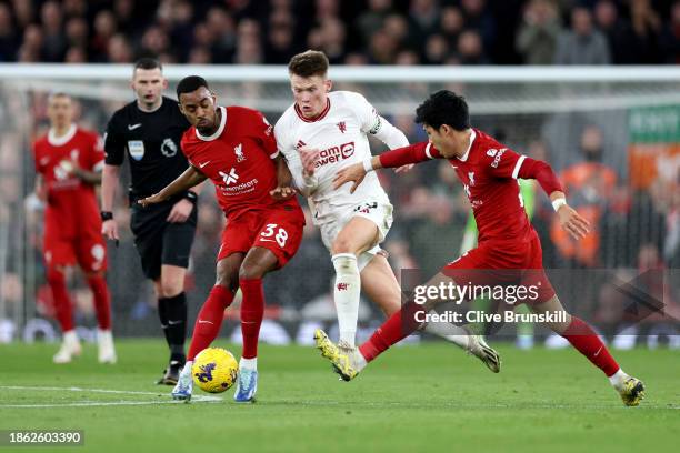 Scott McTominay of Manchester United battles for possession with Ryan Gravenberch and Wataru Endo of Liverpool during the Premier League match...