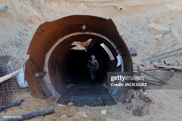 In this picture taken during a media tour organized by the Israeli military on December 15 an Israeli soldier exits a tunnel that Hamas reportedly...