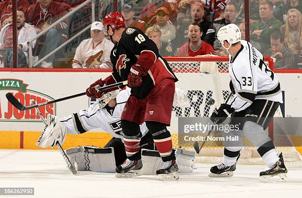 Shane Doan of the Phoenix Coyotes re-directs the puck into the net for a goal past goalie Ben Scrivens and Willie Mitchell of the Los Angeles Kings...