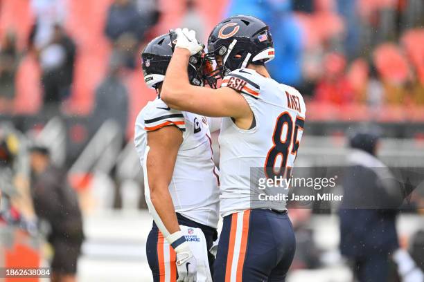 Justin Fields and Cole Kmet of the Chicago Bears warm up prior to a game against the Cleveland Browns at Cleveland Browns Stadium on December 17,...