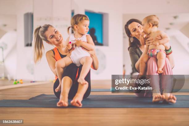 at yoga class - practicing stock pictures, royalty-free photos & images