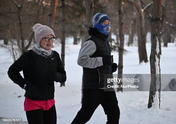 People are running in the morning with frost on their faces in the lowest temperature of -27 degrees in Shenyang, Liaoning Province, China, on...