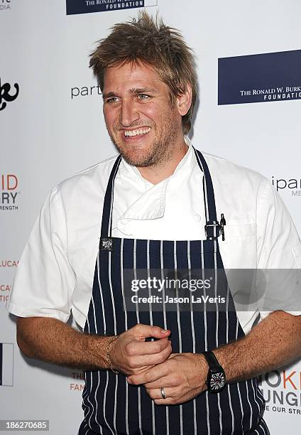 Chef Curtis Stone attends Share Our Strength's No Kid Hungry dinner at Ron Burkle's Green Acres Estate on October 29, 2013 in Beverly Hills,...