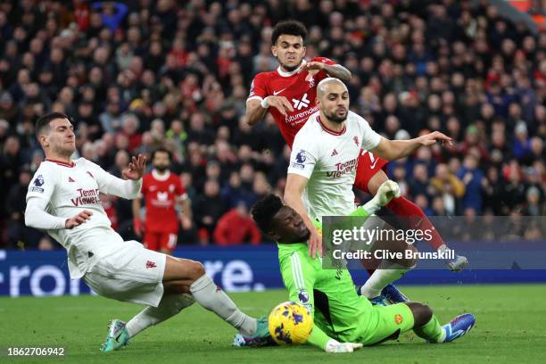 Luis Diaz of Liverpool has a shot blocked by Sofyan Amrabat and Andre Onana of Manchester United during the Premier League match between Liverpool FC...