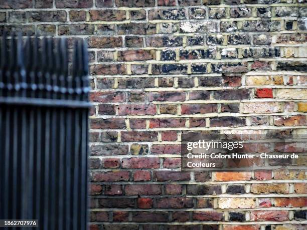 weathered and colored brick wall with railing (blurred) in london, england, united kingdom - steel railings stock pictures, royalty-free photos & images