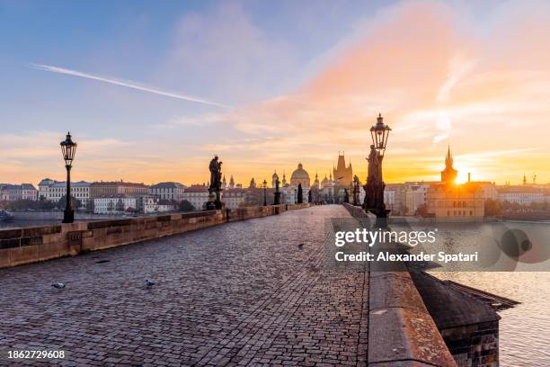 charles bridge and prague old town at sunrise, czech republic - czech republic river stock pictures, royalty-free photos & images