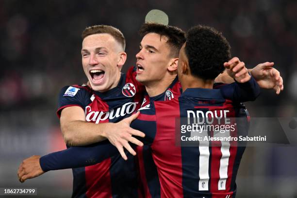 Dan Ndoye of Bologna FC celebrates with teammates after Rasmus Kristensen of AS Roma scored an own goal, Bologna FC's second goal during the Serie A...
