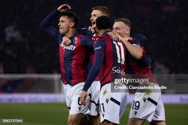 Dan Ndoye of Bologna FC celebrates after scoring his team's second goal with his teammates Lewis Ferguson, Stefan Posch and Nikola Moro of Bologna FC...