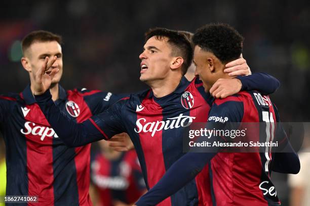 Dan Ndoye of Bologna FC celebrates with teammates after Rasmus Kristensen of AS Roma scored an own goal, Bologna FC's second goal during the Serie A...