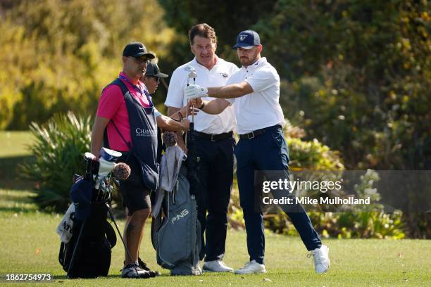 Sir Nick Faldo of England and his son, Matthew Faldo, look on from the 14th tee during the final round of the PNC Championship at The Ritz-Carlton...