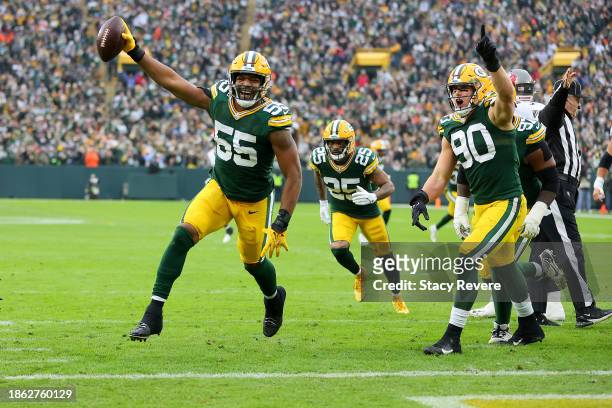 Kingsley Enagbare and Lukas Van Ness of the Green Bay Packers celebrate after Enagbare's fumble recovery during the first quarter against the Tampa...