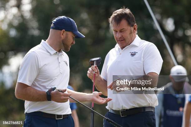 Sir Nick Faldo of England and his son, Matthew Faldo, walk off the 13th green during the final round of the PNC Championship at The Ritz-Carlton Golf...
