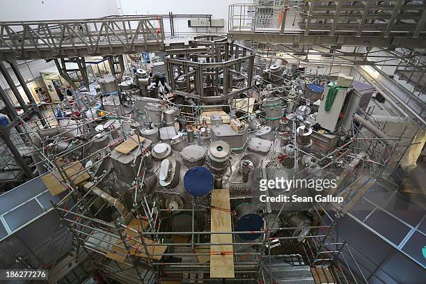 Worker welds a part on the exterior of the Wendelstein 7-X experimental fusion reactor at the Max Planck Institute for Plasma Physics on October 29,...