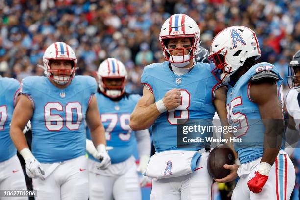 Will Levis of the Tennessee Titans and Chigoziem Okonkwo of the Tennessee Titans celebrate after Levis' rushing touchdown during the first quarter...