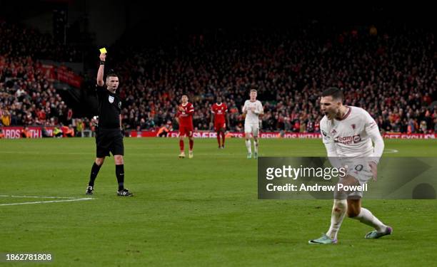 Diogo Dalot of Manchester United receiving his first yellow card from referee Michael Oliver during the Premier League match between Liverpool FC and...