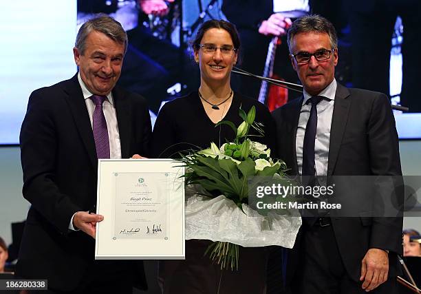 Birgit Prinz is unveiled as the DFB honor team captain by DFB president Wolfgang Niersbach and DFB general secretary Helmut Sandrock at NCC Nuremberg...
