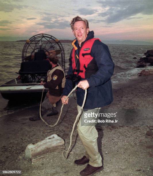 United States Secretary of the Interior Bruce Babbit arrives on shore after an airboat tour at the Salton Sea, December 18, 1997 in Salton City,...