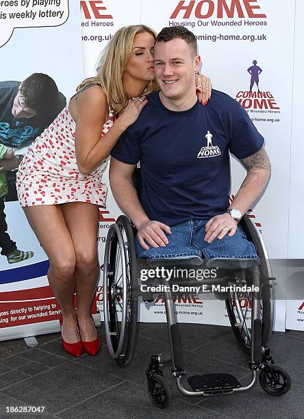 Sarah Harding and Private Michael Swain attend a photocall to launch the Coming Home lottery ticket at Hippodrome Casino on October 30, 2013 in...