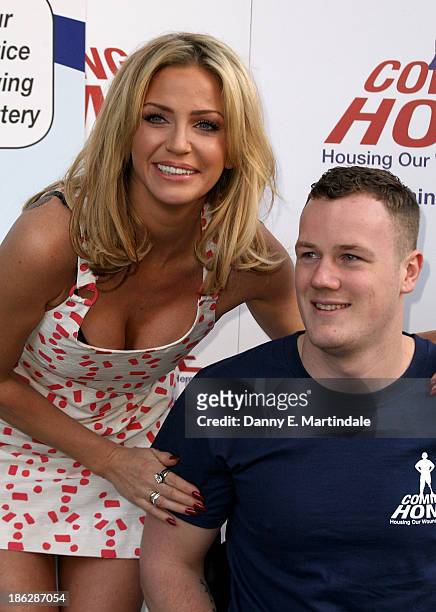 Sarah Harding and Private Michael Swain attend a photocall to launch the Coming Home lottery ticket at Hippodrome Casino on October 30, 2013 in...