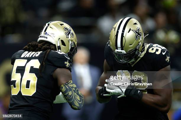 Tanoh Kpassagnon of the New Orleans Saints reacts with Demario Davis during the first half of the game against the New York Giants at Caesars...