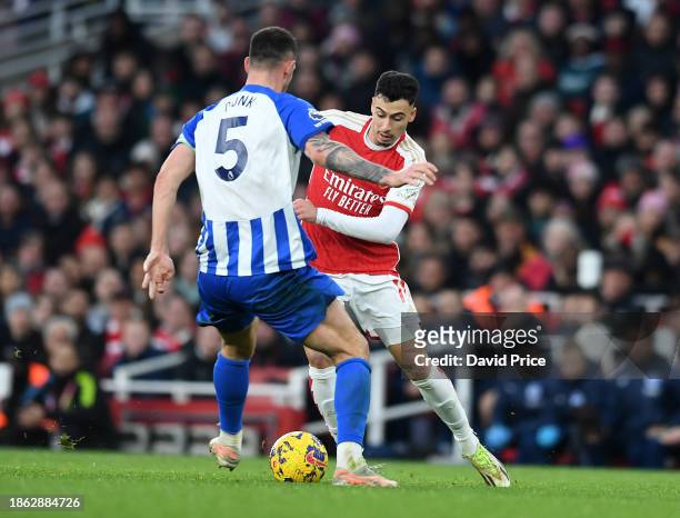 Gabriel Martinelli of Arsenal nutmegs Lewis Dunk of Brighton during the Premier League match between Arsenal FC and Brighton & Hove Albion at...