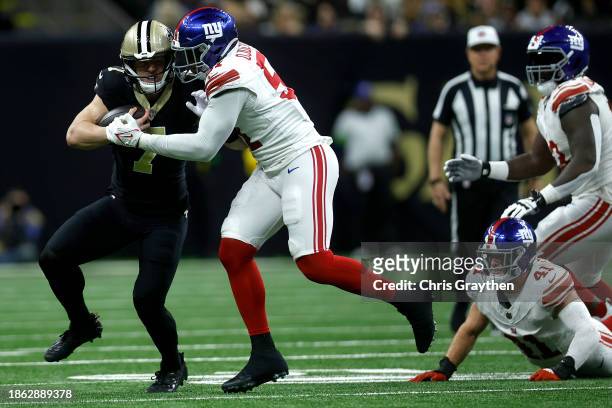 Taysom Hill of the New Orleans Saints carries the ball during the first half of the game against the New York Giants at Caesars Superdome on December...