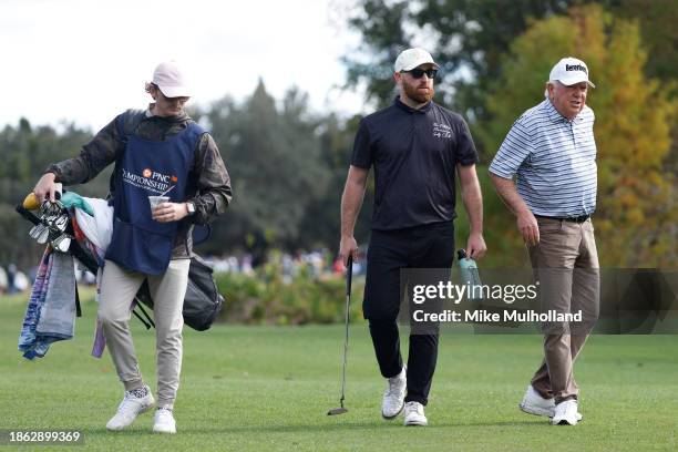 Mark O'meara of the United States and son, Shaun O'Meara, walk on the on the 13th green during the final round of the PNC Championship at The...