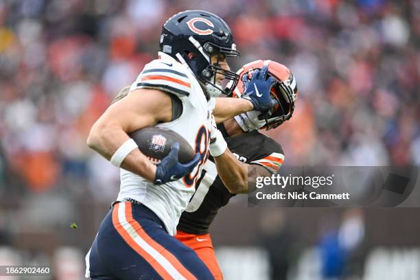 Cole Kmet of the Chicago Bears stiff arms Greg Newsome II of the Cleveland Browns during the second quarter at Cleveland Browns Stadium on December...