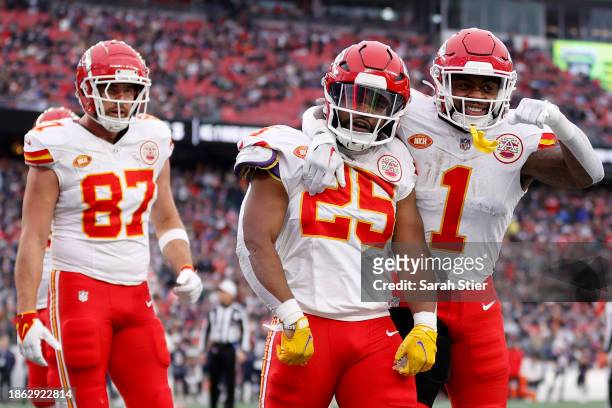 Travis Kelce, Clyde Edwards-Helaire and Jerick McKinnon of the Kansas City Chiefs celebrate after Edwards-Helaire's receiving touchdown during the...