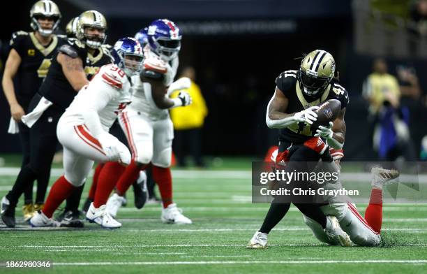 Alvin Kamara of the New Orleans Saints carries the ball during the second half of the game against the New York Giants at Caesars Superdome on...