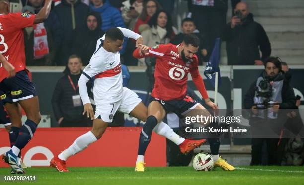 Kylian Mbappe of Paris Saint-Germain in action with Nabil Bentaleb of Lille during the Ligue 1 Uber Eats match between Lille OSC and Paris...