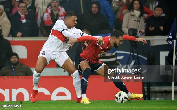 Kylian Mbappe of Paris Saint-Germain in action with Nabil Bentaleb of Lille during the Ligue 1 Uber Eats match between Lille OSC and Paris...