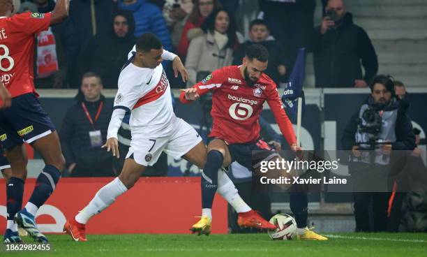 Kylian Mbappe of Paris Saint-Germain in action with Nabil Bentaleb of Lille during the Ligue 1 Uber Eats match between Lille OSC and Paris...