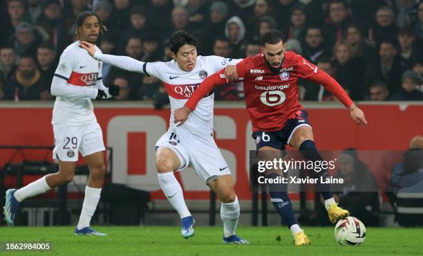 Lee Kang-In of Paris Saint-Germain in action with Nabil Bentaleb of Lille during the Ligue 1 Uber Eats match between Lille OSC and Paris...