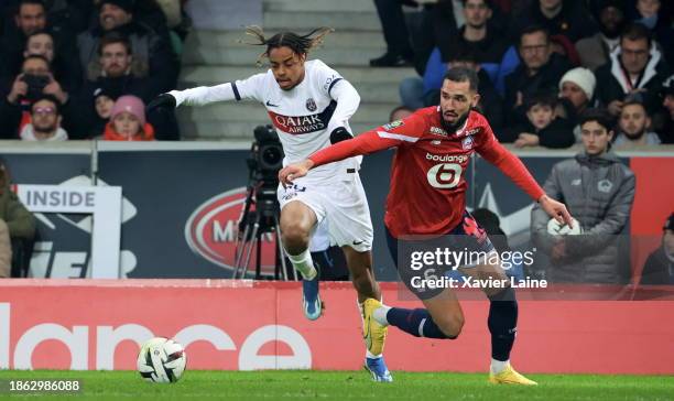 Bradley Barcola of Paris Saint-Germain in action with Nabil Bentaleb of Lille during the Ligue 1 Uber Eats match between Lille OSC and Paris...