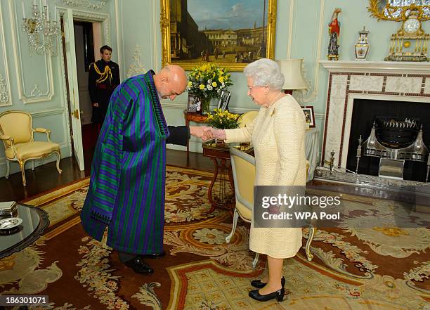 President of Afghanistan Hamid Karzai attends an audience with Queen Elizabeth II at Buckingham Palace on October 30, 2013 in London, England. The...